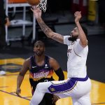 Los Angeles Lakers forward Anthony Davis, right, reaches for a rebound over Phoenix Suns guard Chris Paul during the first half of an NBA basketball game Sunday, May 9, 2021, in Los Angeles. (AP Photo/Marcio Jose Sanchez)