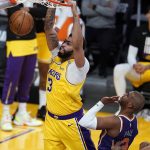 Los Angeles Lakers forward Anthony Davis (3) dunks past Phoenix Suns guard Chris Paul (3) during the second half in Game 3 of an NBA basketball first-round playoff series Thursday, May 27, 2021, in Los Angeles. (AP Photo/Marcio Jose Sanchez)