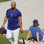 Los Angeles Dodgers first baseman Albert Pujols, left, walks away after batting practice as third baseman Justin Turner sits in the background prior to a baseball game against the Arizona Diamondbacks Monday, May 17, 2021, in Los Angeles. (AP Photo/Mark J. Terrill)