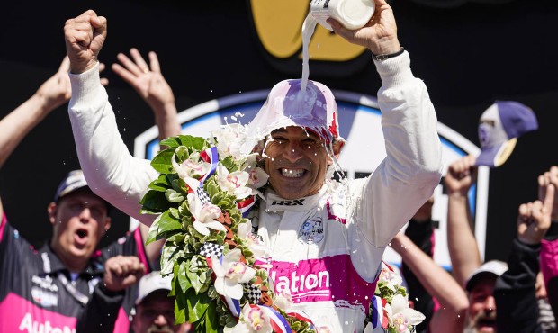 Helio Castroneves of Brazil celebrates after winning the Indianapolis 500 auto race at Indianapolis...