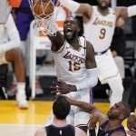 Los Angeles Lakers center Montrezl Harrell dunks over Phoenix Suns guard Chris Paul, right, and Frank Kaminsky (8) during the second half of an NBA basketball game against the Phoenix Suns on Sunday, May 9, 2021, in Los Angeles. (AP Photo/Marcio Jose Sanchez)