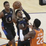 New York Knicks guard Elfrid Payton (6) shoots over Phoenix Suns center Deandre Ayton (22) during the first half of an NBA basketball game, Friday, May 7, 2021, in Phoenix. (AP Photo/Rick Scuteri)