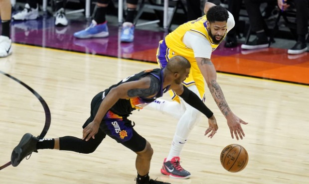 Phoenix Suns guard Chris Paul, left, battles with Los Angeles Lakers forward Anthony Davis, right, ...