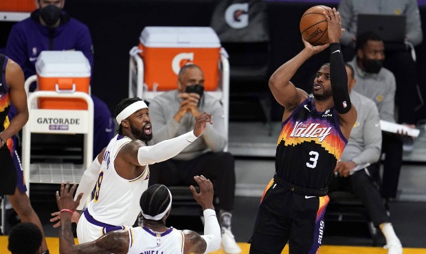 Phoenix Suns guard Chris Paul, right, shoots over Los Angeles Lakers guard Kentavious Caldwell-Pope...