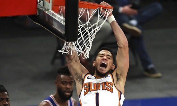 Phoenix Suns' Devin Booker (1) celebrates after his dunk against the New York Knicks in the third q...