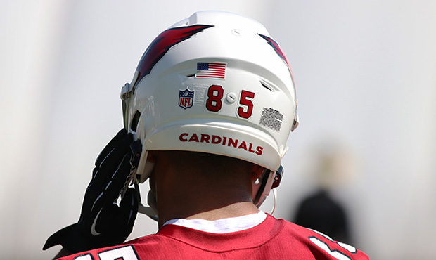 Arizona Cardinals rookie wide receiver Rondale Moore adjusts his helmet during rookie minicamp Frid...