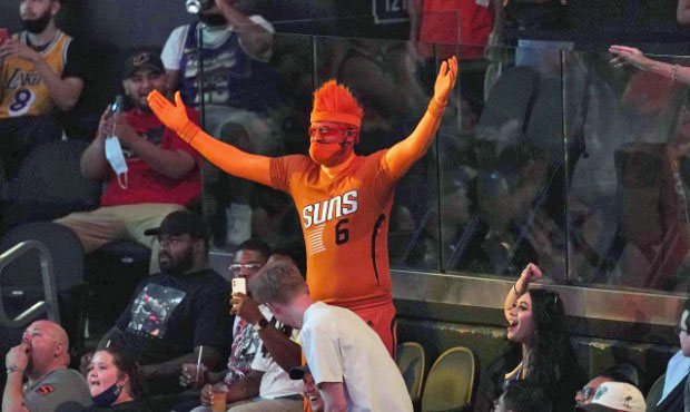 A Phoenix Suns fan cheers on his team during the second half of Game 1 of an NBA basketball first-r...
