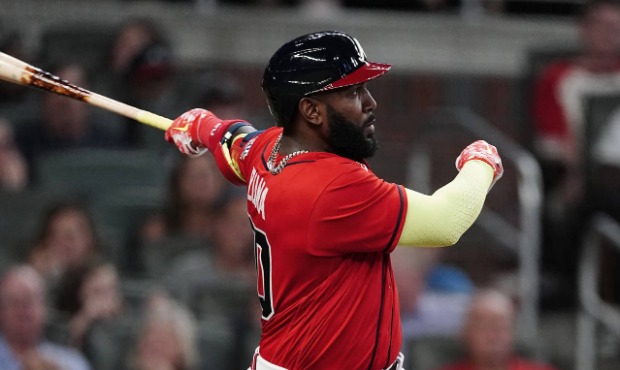 Atlanta Braves' Marcell Ozuna (20) follows through on a solo home run during the sixth inning of th...