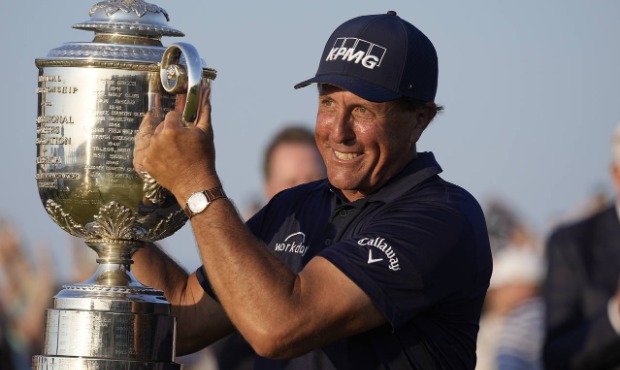 Phil Mickelson holds the Wanamaker Trophy after winning the PGA Championship golf tournament on the...