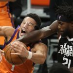 Patrick Beverley #21 of the LA Clippers knocks the ball from the hands of Devin Booker #1 of the Phoenix Suns during the first half in game three of the Western Conference Finals at Staples Center on June 24, 2021 in Los Angeles, California. (Photo by Sean M. Haffey/Getty Images)