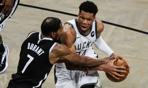 Brooklyn Nets' Kevin Durant (7) defends against Milwaukee Bucks' Giannis Antetokounmpo during the s...