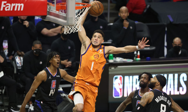 Devin Booker #1 of the Phoenix Suns dunks against the LA Clippers during the first half in Game Six...