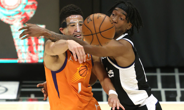 Terance Mann #14 of the LA Clippers pressures Devin Booker #1 of the Phoenix Suns during the second...