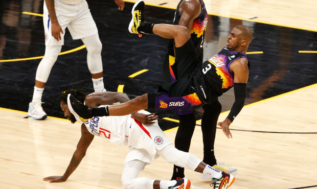 Chris Paul #3 of the Phoenix Suns is fouled by Patrick Beverley #21 of the LA Clippers during the s...