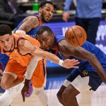 DENVER, CO - JUNE 11:  Devin Booker #1 of the Phoenix Suns is defended by Paul Millsap #4 of the Denver Nuggets in Game Three of the Western Conference second-round playoff series at Ball Arena on June 11, 2021 in Denver, Colorado. (Photo by Dustin Bradford/Getty Images)