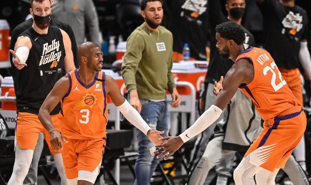 Chris Paul #3 of the Phoenix Suns is congratulated by Deandre Ayton #22 after a basket in Game Thre...