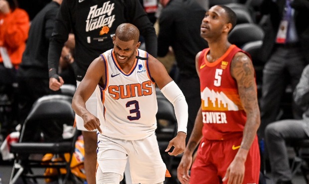 Chris Paul #3 of the Phoenix Suns celebrates towards Will Barton #5 of the Denver Nuggets after sco...