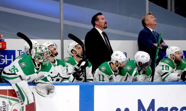 Head coach Rick Bowness (R) and assistant coach Todd Nelson of the Dallas Stars look up at the vide...