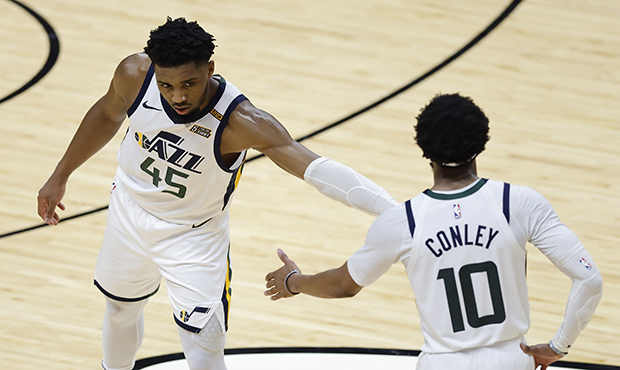 Donovan Mitchell #45 of the Utah Jazz high fives Mike Conley #10 against the Miami Heat during the ...