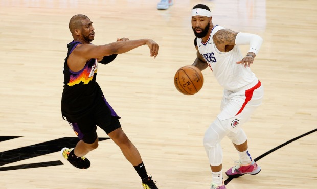Chris Paul #3 of the Phoenix Suns passes the ball around Marcus Morris Sr. #8 of the LA Clippers du...