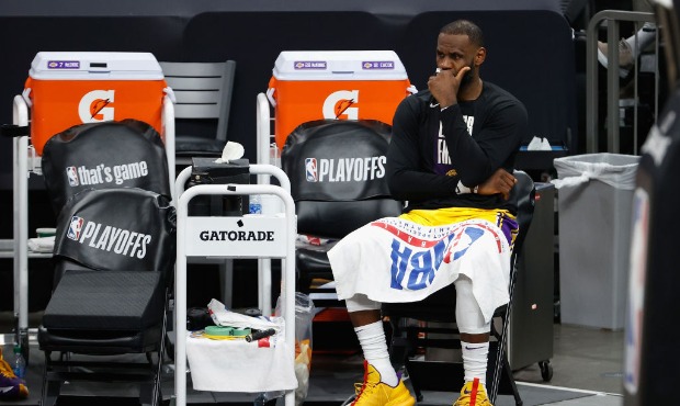 LeBron James #23 of the Los Angeles Lakers reacts on the bench during the second half in Game Five ...