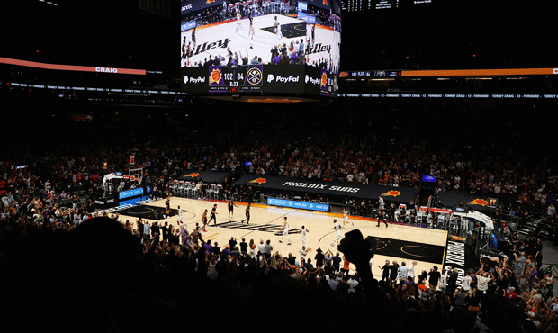 Fans cheer after Chris Paul #3 of the Phoenix Suns scored against the Denver Nuggets during the sec...