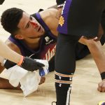 PHOENIX, ARIZONA - JUNE 22: Devin Booker #1 of the Phoenix Suns is injured from a headbutt during the third quarter in game two of the NBA Western Conference finals against the LA Clippers at Phoenix Suns Arena on June 22, 2021 in Phoenix, Arizona. NOTE TO USER: User expressly acknowledges and agrees that, by downloading and or using this photograph, User is consenting to the terms and conditions of the Getty Images License Agreement.  (Photo by Christian Petersen/Getty Images)
