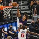 PHOENIX, ARIZONA - JUNE 22: Cameron Johnson #23 of the Phoenix Suns drives to the basket over Paul George #13 of the LA Clippers during the third quarter in game two of the NBA Western Conference finals at Phoenix Suns Arena on June 22, 2021 in Phoenix, Arizona. NOTE TO USER: User expressly acknowledges and agrees that, by downloading and or using this photograph, User is consenting to the terms and conditions of the Getty Images License Agreement.  (Photo by Christian Petersen/Getty Images)