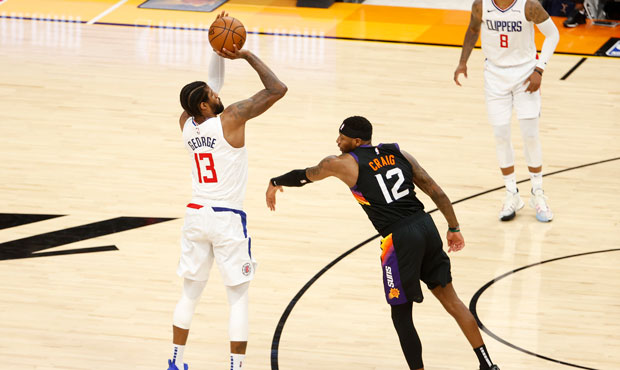 Paul George #13 of the LA Clippers shoots against Torrey Craig #12 of the Phoenix Suns during the s...