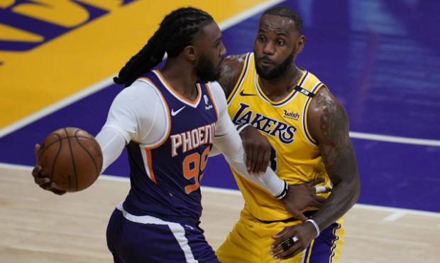 Los Angeles Lakers forward LeBron James (23) defends against Phoenix Suns forward Jae Crowder (99) ...