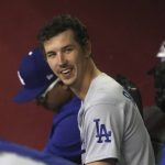 Los Angeles Dodgers pitcher Walker Buehler smiles after getting pulled during the eighth inning of the team's baseball game against the Arizona Diamondbacks, Saturday, June 19, 2021, in Phoenix. (AP Photo/Rick Scuteri)