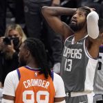 Los Angeles Clippers guard Paul George, right, reacts after being charged with a foul as Phoenix Suns forward Jae Crowder stands by during the second half in Game 4 of the NBA basketball Western Conference Finals Saturday, June 26, 2021, in Los Angeles. (AP Photo/Mark J. Terrill)