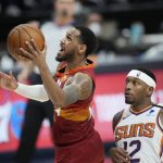 Denver Nuggets guard Monte Morris, left, drives to the rim past Phoenix Suns forward Torrey Craig in the second half of Game 4 of an NBA second-round playoff series, Sunday, June 13, 2021, in Denver. Phoenix won 125-118 to sweep the series. (AP Photo/David Zalubowski)