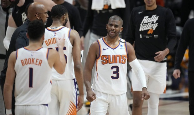 Phoenix Suns guard Chris Paul congratulates teammates during a timeout in the second half of Game 4...