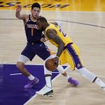 Phoenix Suns guard Devin Booker (1) defends against Los Angeles Lakers forward LeBron James (23) during the fourth quarter of Game 6 of an NBA basketball first-round playoff series Thursday, June 3, 2021, in Los Angeles. (AP Photo/Ashley Landis)