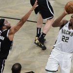 Milwaukee Bucks' Khris Middleton (22) shoots over Brooklyn Nets' Bruce Brown (1) during overtime of Game 7 of a second-round NBA basketball playoff series Saturday, June 19, 2021, in New York. (AP Photo/Frank Franklin II)