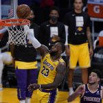 Los Angeles Lakers forward LeBron James (23) scores against Phoenix Suns guard Devin Booker (1) during the third quarter of Game 6 of an NBA basketball first-round playoff series Thursday, June 3, 2021, in Los Angeles. (AP Photo/Ashley Landis)