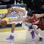 Denver Nuggets guard Facundo Campazzo, right, tries to steal the ball from Phoenix Suns guard Devin Booker in the second half of Game 4 of an NBA second-round playoff series, Sunday, June 13, 2021, in Denver. (AP Photo/David Zalubowski)