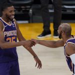 Phoenix Suns forward Mikal Bridges (25) and guard Jevon Carter (4) celebrate after winning 113-100 over the Los Angeles Lakers of Game 6 of an NBA basketball first-round playoff series Thursday, June 3, 2021, in Los Angeles. The Suns won the series 4-2 and will move on to round 2. (AP Photo/Ashley Landis)