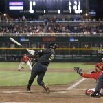 Vanderbilt's Jayson Gonzalez (99) hits a single to drive in the winning run against Arizona in the 12th inning of a baseball game in the NCAA College World Series on Saturday, June 19, 2021, in Omaha, Neb. (AP Photo/Rebecca S. Gratz)