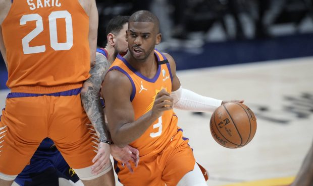 Phoenix Suns guard Chris Paul drives as Denver Nuggets guard Facundo Campazzo is slowed by screen b...