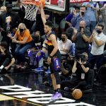 Phoenix Suns guard Devin Booker (1) dunks against the Denver Nuggets during the first half of Game 2 of an NBA basketball second-round playoff series, Wednesday, June 9, 2021, in Phoenix. (AP Photo/Matt York)