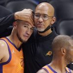 Phoenix Suns head coach Monty Williams, center, hugs Devin Booker, left, as Chris Paul stands by as time runs out in Game 6 of the NBA basketball Western Conference Finals against the Los Angeles Clippers Wednesday, June 30, 2021, in Los Angeles. The Suns won the game 130-103 to take the series 4-2. (AP Photo/Mark J. Terrill)