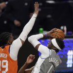 Los Angeles Clippers guard Reggie Jackson, right, shoots as Phoenix Suns forward Jae Crowder defends during the second half in Game 4 of the NBA basketball Western Conference Finals Saturday, June 26, 2021, in Los Angeles. (AP Photo/Mark J. Terrill)