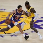 Los Angeles Lakers guard Dennis Schroder, right, defends against Phoenix Suns guard Cameron Payne (15) during the third quarter of Game 6 of an NBA basketball first-round playoff series Thursday, June 3, 2021, in Los Angeles. (AP Photo/Ashley Landis)