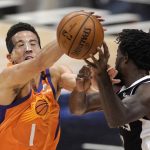 Phoenix Suns guard Devin Booker, left, blocks a pass intended for Los Angeles Clippers guard Patrick Beverley during the first half in Game 3 of the NBA basketball Western Conference Finals Thursday, June 24, 2021, in Los Angeles. (AP Photo/Mark J. Terrill)