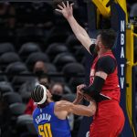 Portland Trail Blazers center Jusuf Nurkic, right, shoots next to Denver Nuggets forward Aaron Gordon (50) during the first half of Game 5 of a first-round NBA basketball playoff series Tuesday, June 1, 2021, in Denver. (AP Photo/Jack Dempsey)