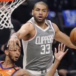 Phoenix Suns guard Cameron Payne, left, is hit in the face by Los Angeles Clippers forward Nicolas Batum as he passes the ball during the first half in Game 4 of the NBA basketball Western Conference Finals Saturday, June 26, 2021, in Los Angeles. (AP Photo/Mark J. Terrill)