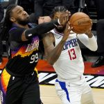 Los Angeles Clippers guard Paul George (13) looks to pass as Phoenix Suns forward Jae Crowder (99) defends during the second half of game 5 of the NBA basketball Western Conference Finals, Monday, June 28, 2021, in Phoenix. (AP Photo/Matt York)