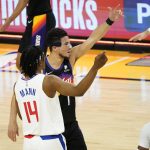 Phoenix Suns guard Devin Booker and Los Angeles Clippers guard Terance Mann (14) point the officials during the first half of game 5 of the NBA basketball Western Conference Finals, Monday, June 28, 2021, in Phoenix. (AP Photo/Matt York)
